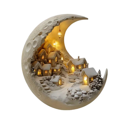 Decorative moon-shaped ornament with a small village scene inside, glowing warmly.