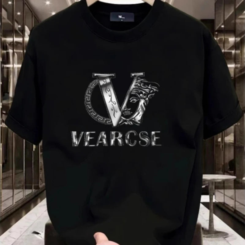Black t-shirt with a silver logo and text held in front of a reflective surface.