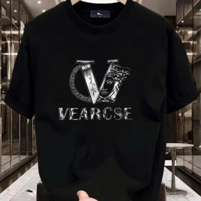 Black t-shirt with a silver logo and text held in front of a reflective surface.