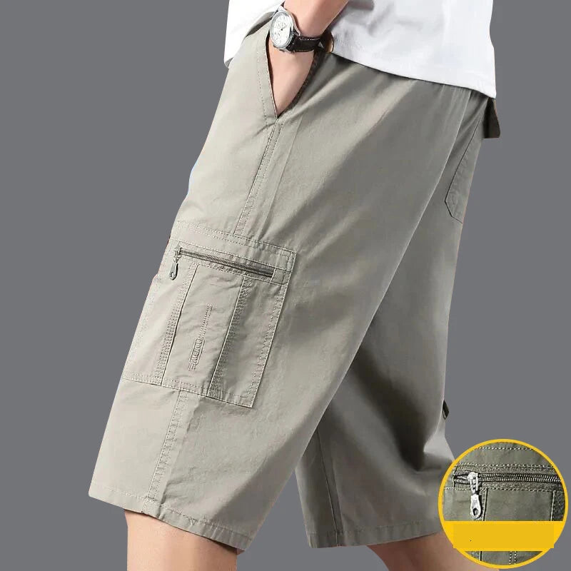 Person wearing gray cargo shorts on a gray background