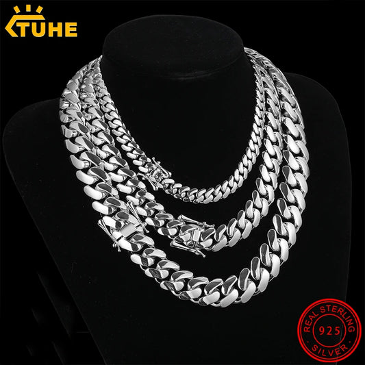 Silver chain necklace on a black stand with 'TUHE' branding and '925' stamp.