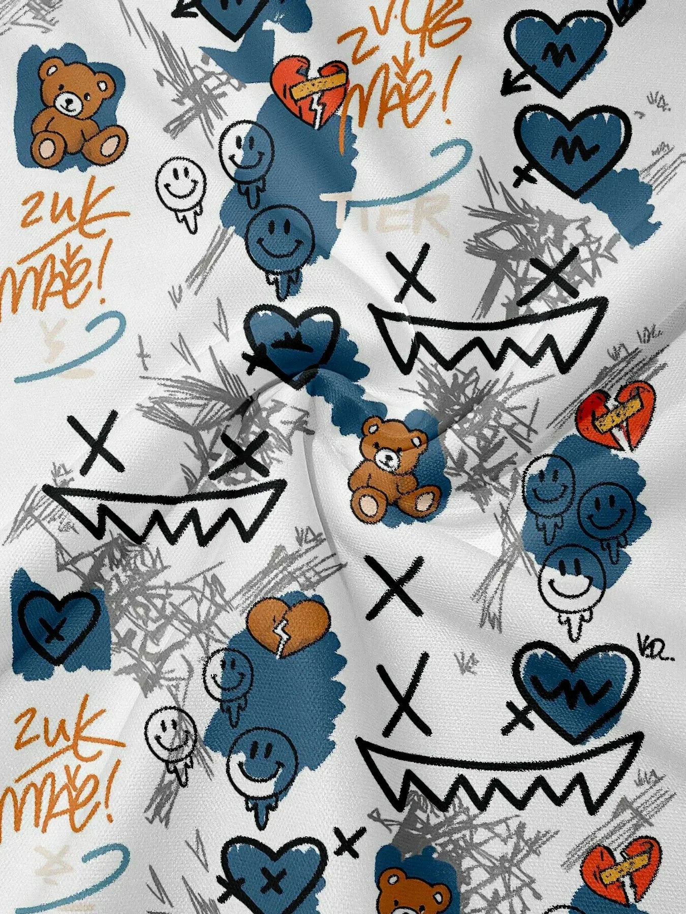 Patterned fabric with various symbols including teddy bears, hearts, and smiley faces on a white background.