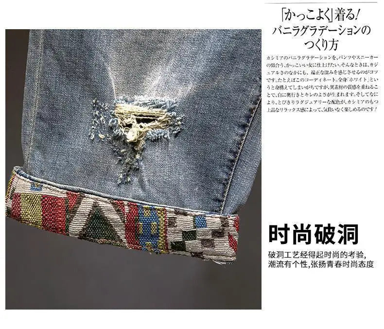 Close-up of a denim fabric with decorative stitching and beads on a gray background