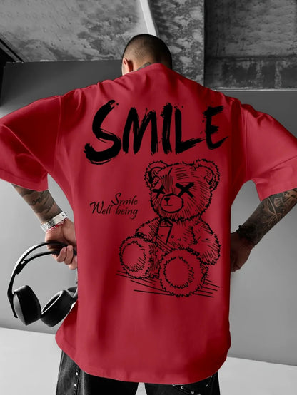 Person wearing a red shirt with a teddy bear graphic and 'SMILE' text.