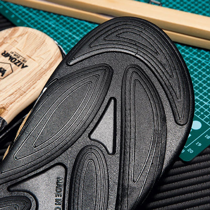 Close-up of a black sole with tread pattern on a green cutting mat