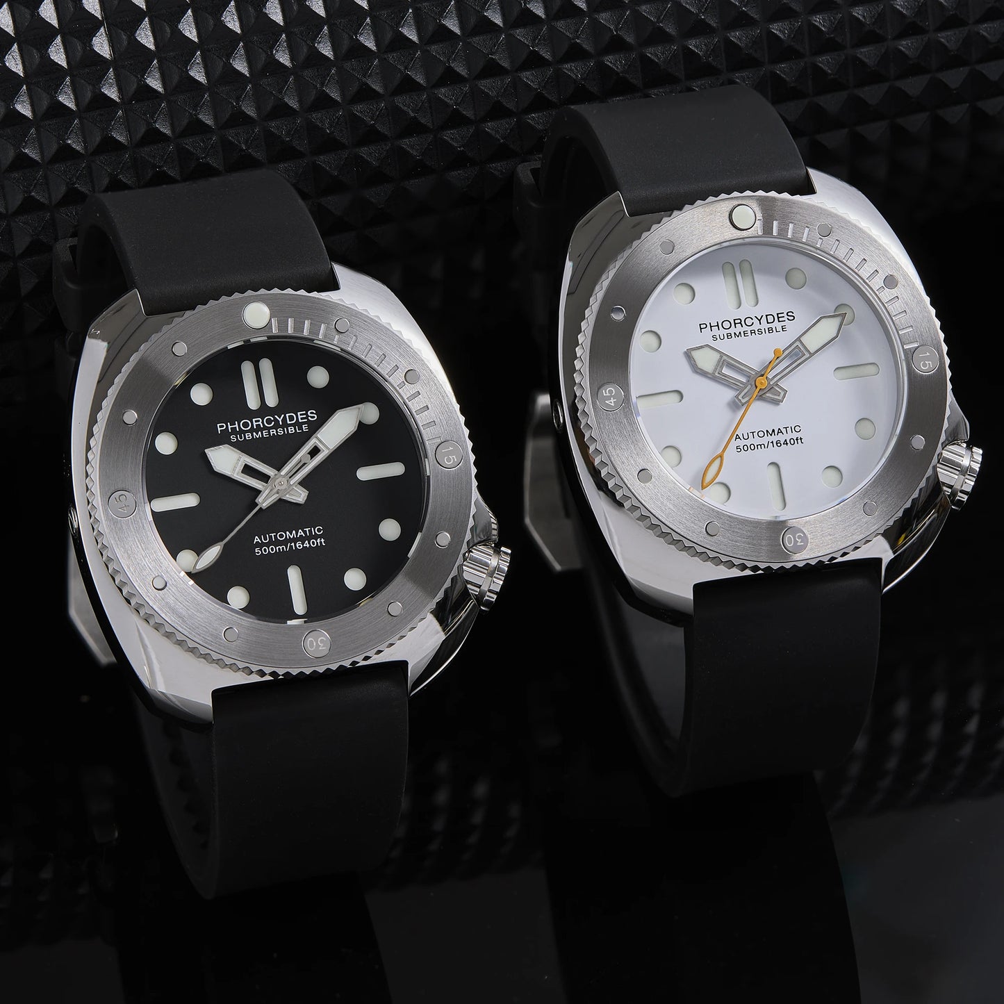 Two watches with black and silver designs on a textured black background