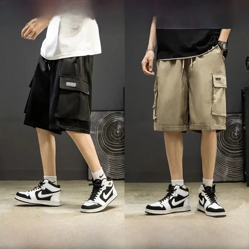 Two people wearing black and white sneakers with cargo shorts on a dark background