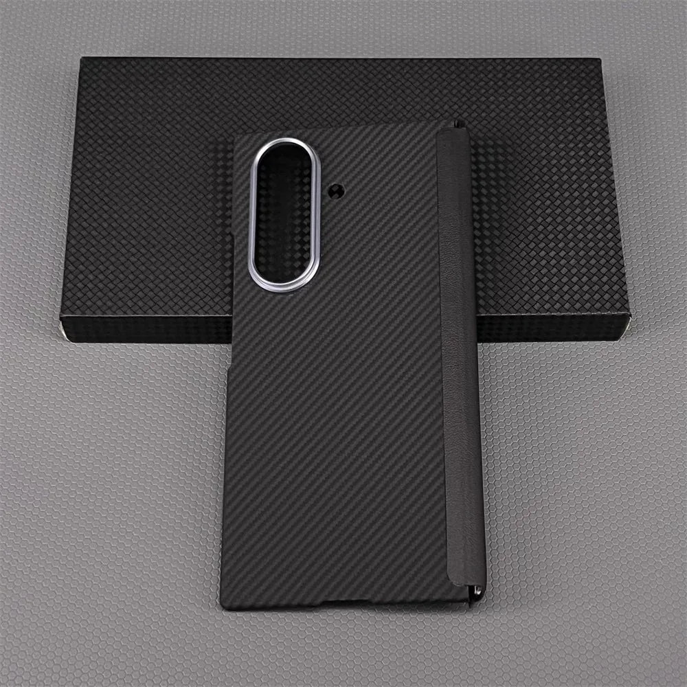 Black carbon fiber phone case on a gray background