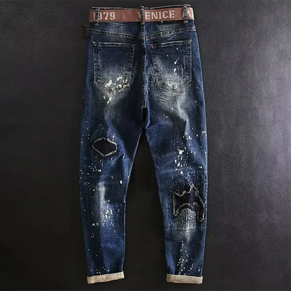 Distressed blue jeans with a brown belt on a dark background