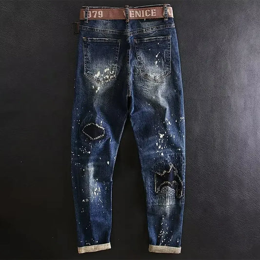 Distressed blue jeans with a brown belt on a dark background