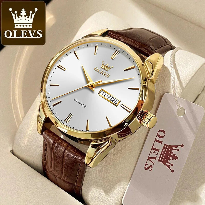 Gold watch with brown leather strap on a white cushion, featuring the OLEVS brand.