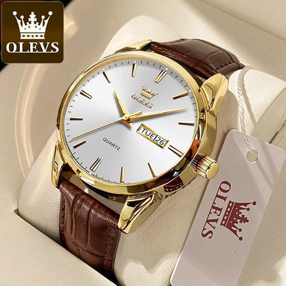Gold watch with brown leather strap on a white cushion, featuring the OLEVS brand.