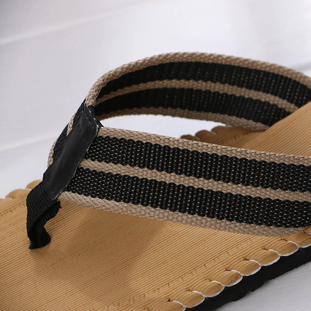 Close-up of a sandal with striped strap on a white background