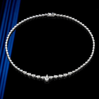Diamond necklace on a black background with blue fabric