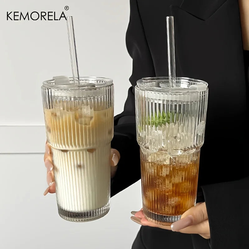 Two glasses of iced beverages held by a person, with 'KEMORELA' branding.
