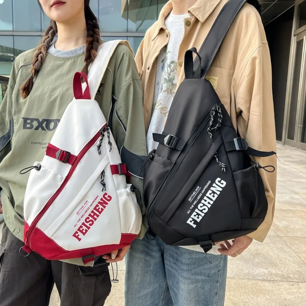 Two people holding FEISHENG bags, one white and red, the other black.