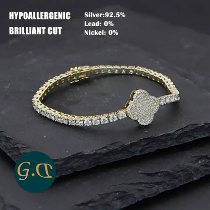 Gold bracelet with diamond accents on a dark stone surface, featuring hypoallergenic information.