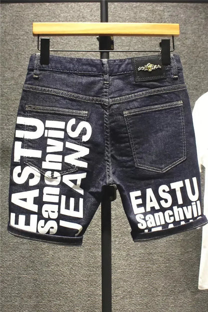 Black denim shorts with white text on a hanger against a gray background