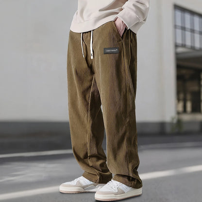 Person wearing brown corduroy pants with a blurred background