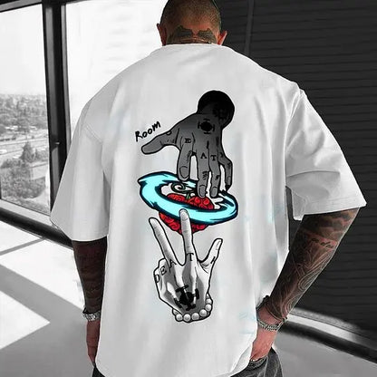 Person wearing a white t-shirt with graphic designs on the back, standing indoors.