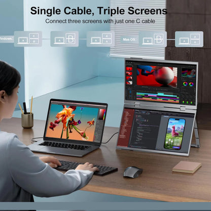 Person using a laptop with a single cable connected to three screens in a home office setting.