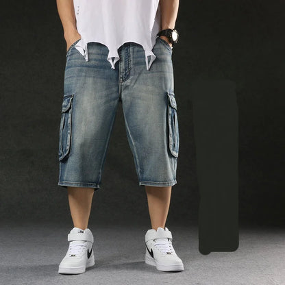 Person wearing blue cargo shorts and white sneakers on a dark background