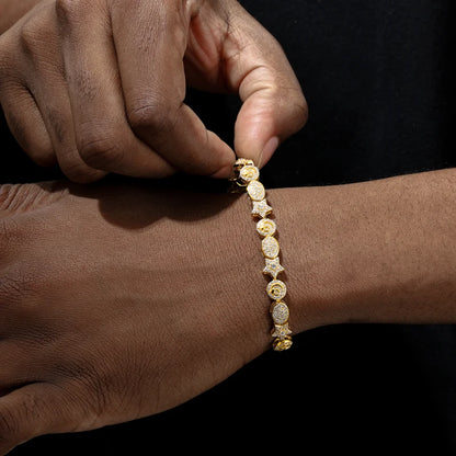 Gold bracelet being adjusted on a wrist against a dark background