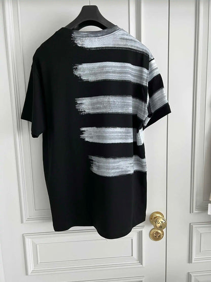 Black and white striped shirt on a hanger against a white door.