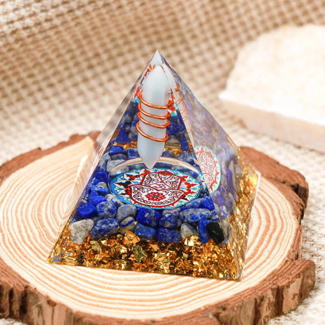Crystal pyramid with colorful stones on a wooden base