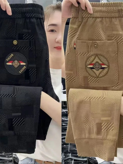 Black and brown pants with a logo on a person wearing them.
