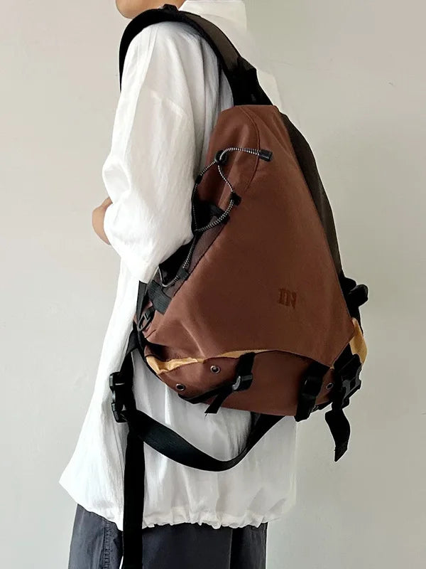 Person wearing a brown backpack with a plain background