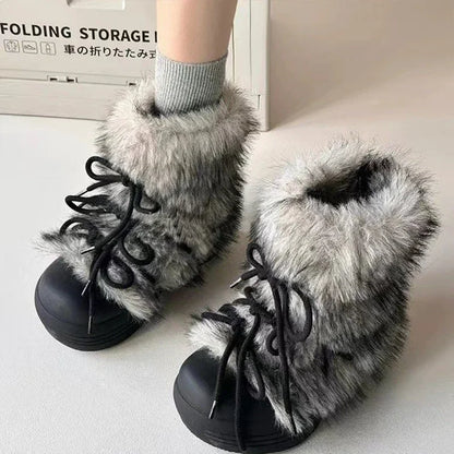 Black boots with gray fur trim worn indoors on a light surface.