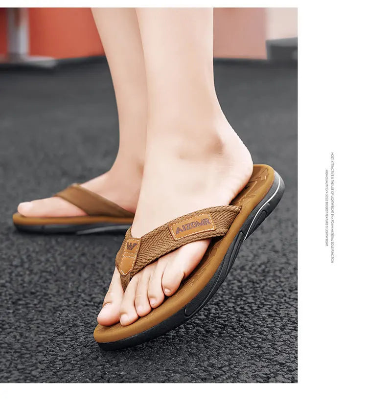 Brown sandals worn on a person's feet on a dark surface