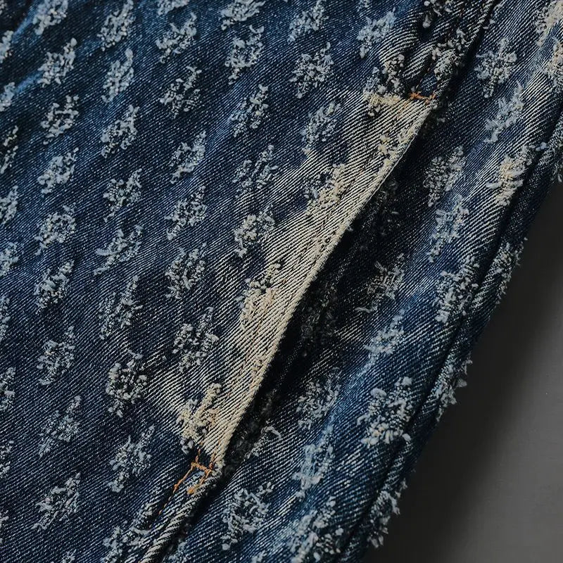 Close-up of blue denim fabric with subtle pattern on a dark background