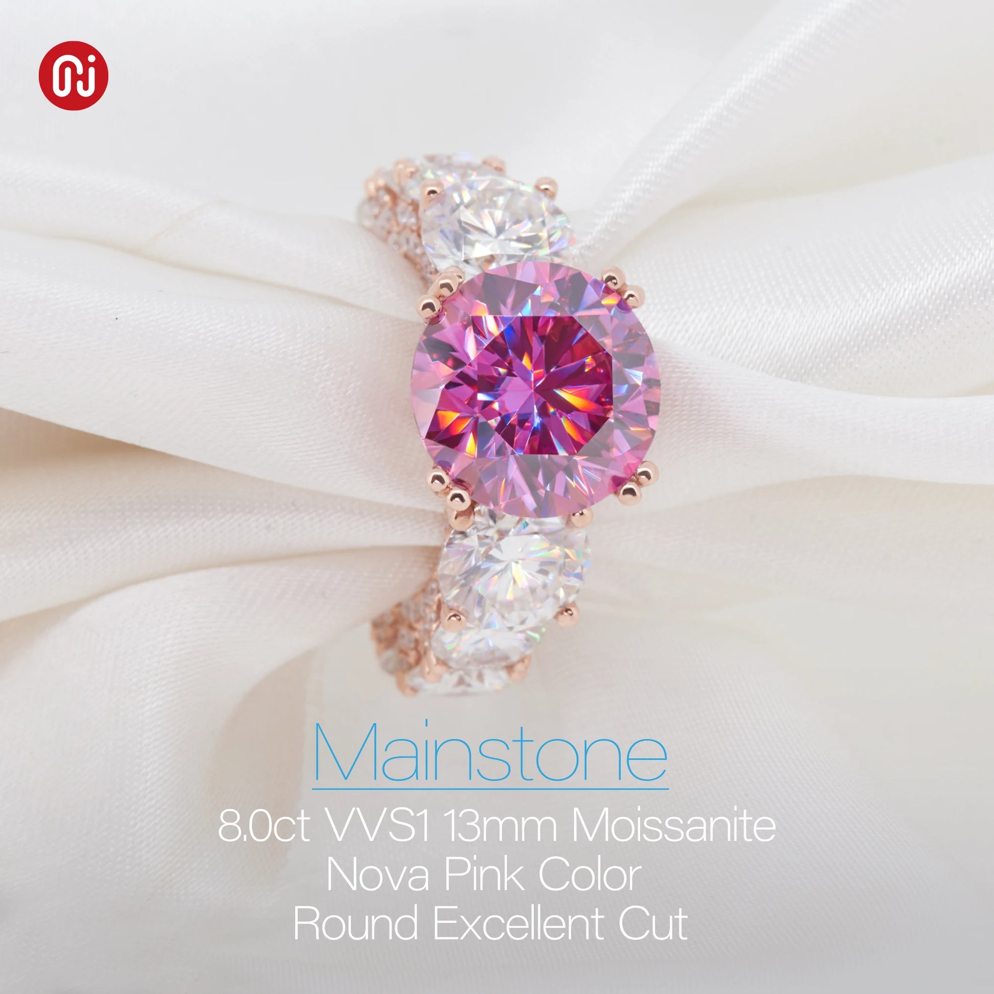Pink gemstone earring on a white fabric background with 'Mainstone' branding.