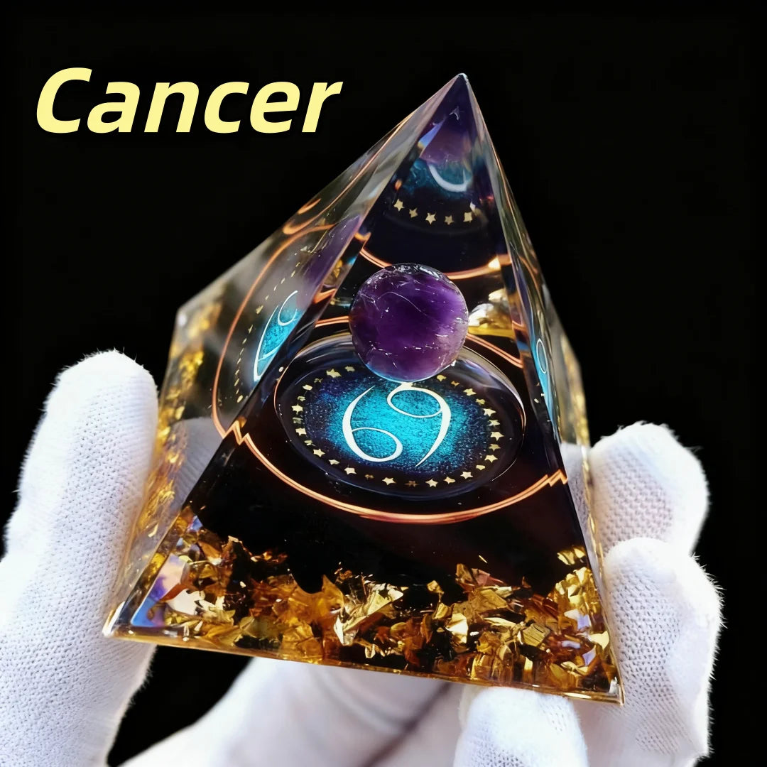 Crystal pyramid with 'Cancer' text held by a gloved hand on a black background