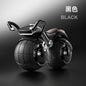 Black toy motorcycle with spherical wheels on a dark background