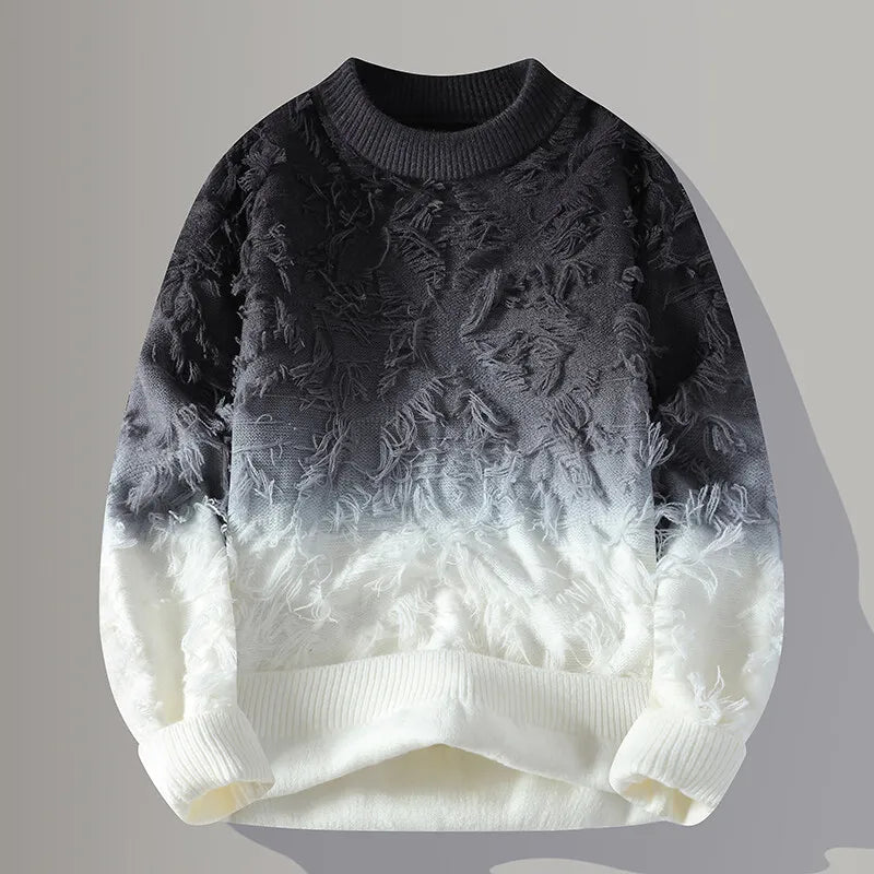 Gradient sweater with textured design transitioning from black to white on a gray background