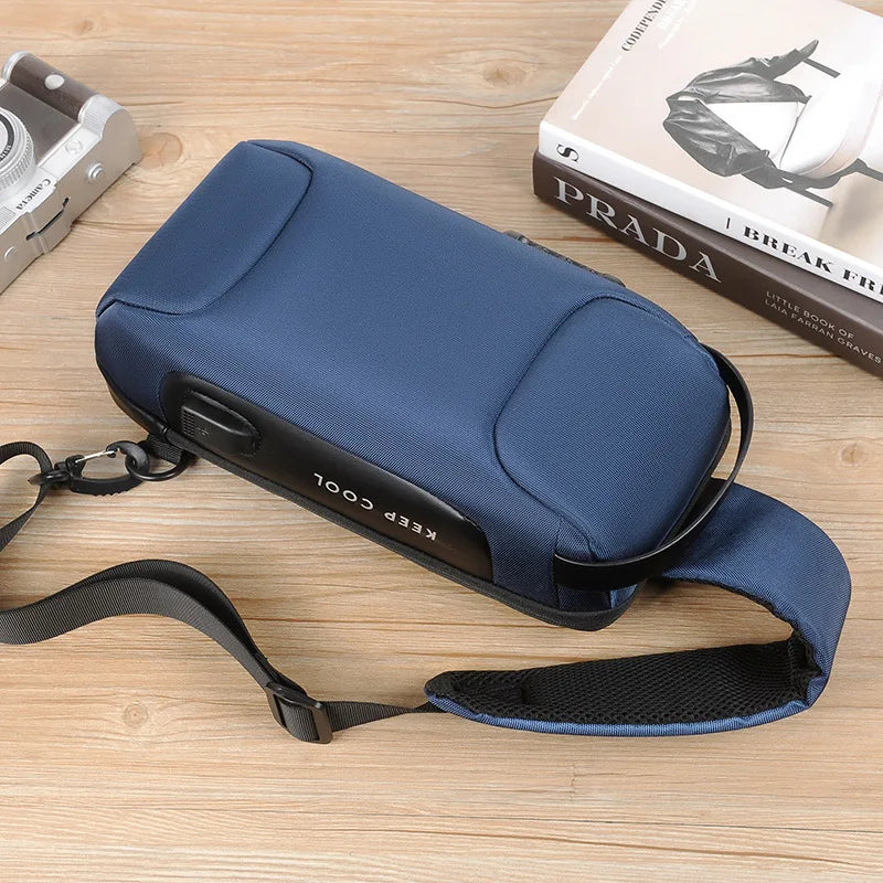 Blue cooler bag with a strap on a wooden surface next to a Prada book