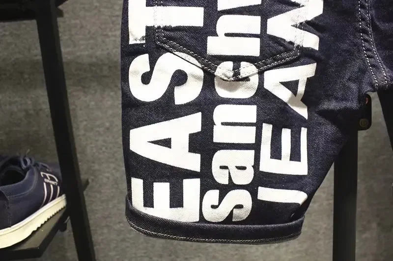 Close-up of a denim product with 'East West Jeans' branding on a stand.