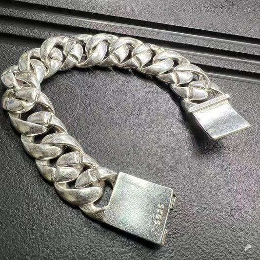 Silver chain bracelet on a textured surface