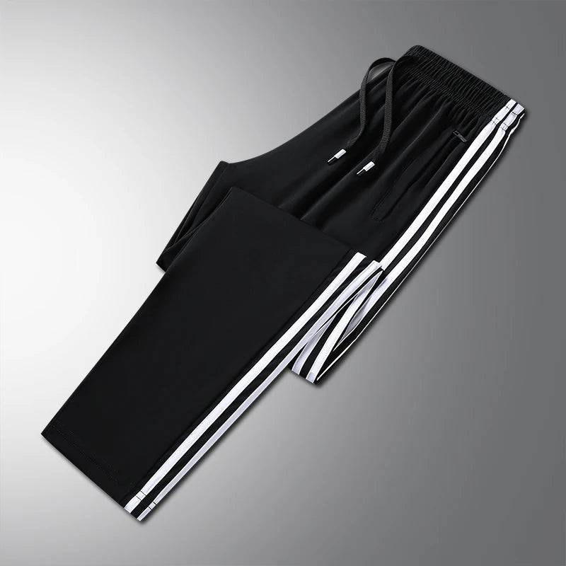 Black pants with white stripes on a gray background