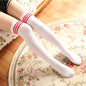 White thigh-high socks with red stripes on a floral rug