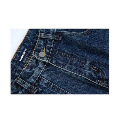 Close-up of blue denim jeans with a brand label on a white background
