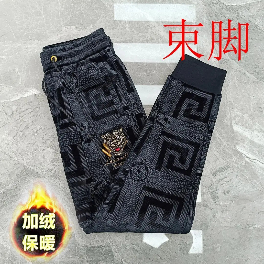 Black pants with geometric pattern on a textured gray background