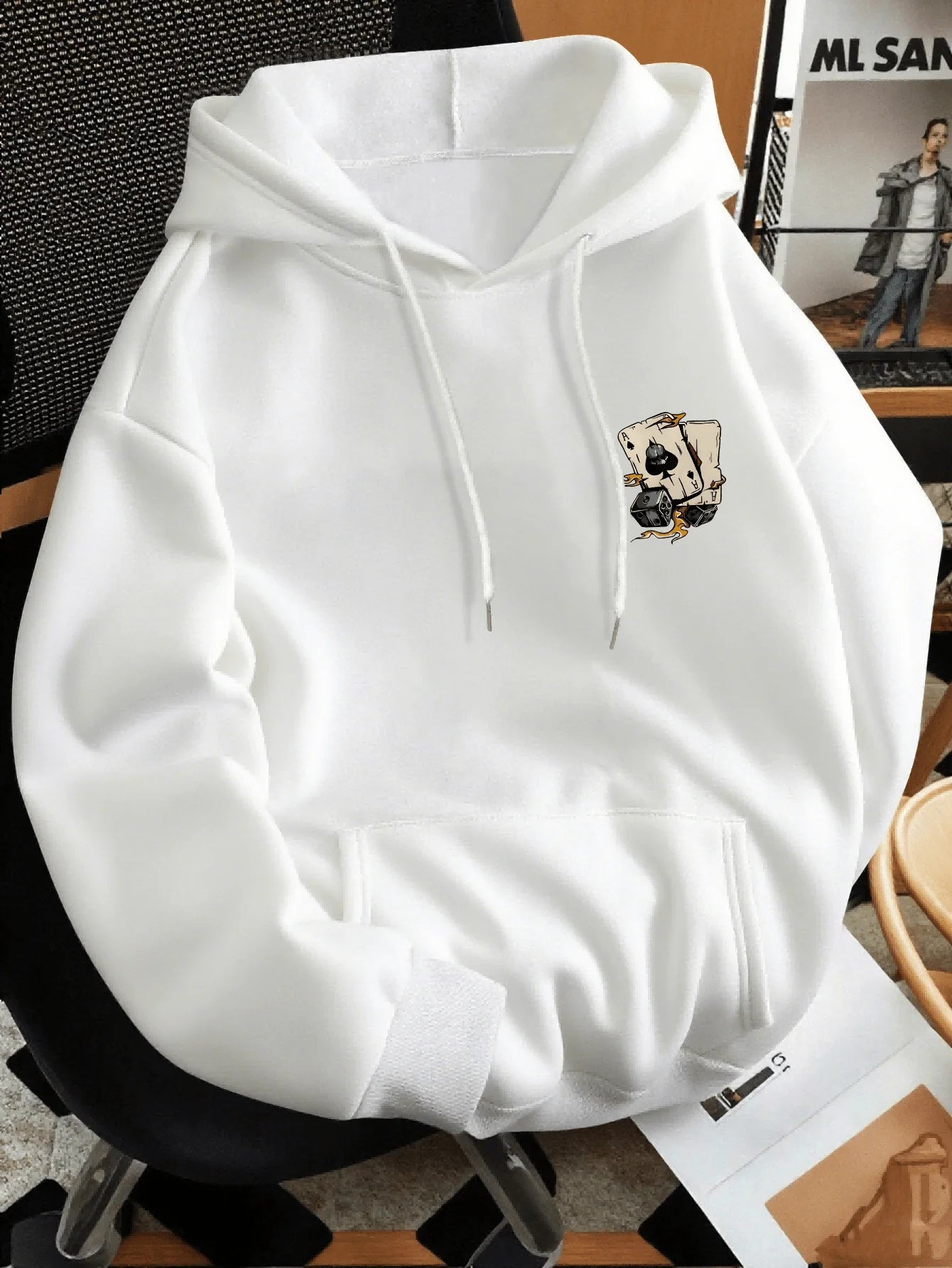 White hoodie with a graphic design on a chair