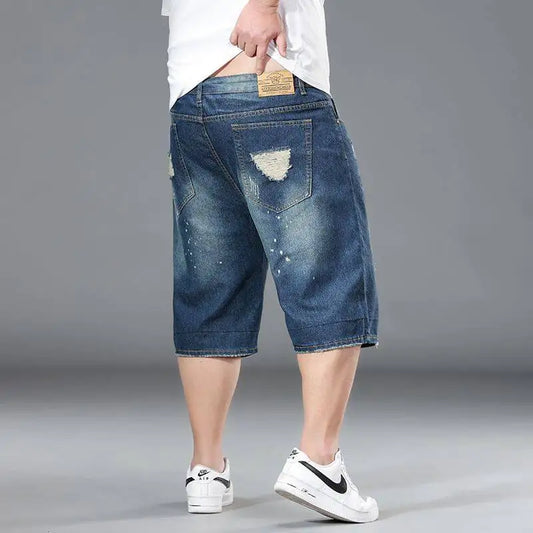 Person wearing blue denim shorts on a gray background
