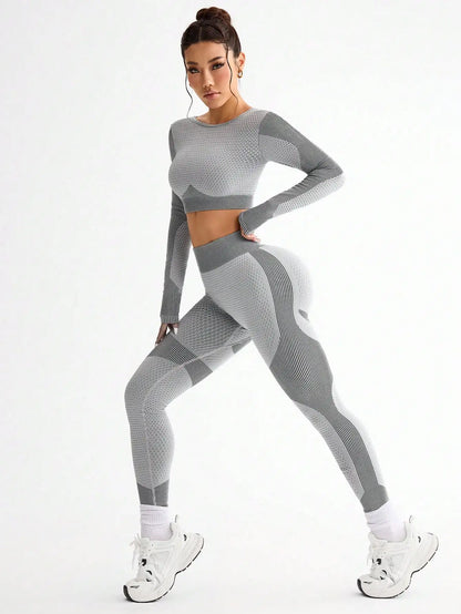 Woman wearing a gray athletic outfit on a white background
