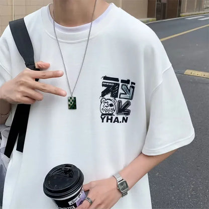 Person wearing a white t-shirt with black graphics and text, holding a coffee cup.