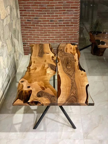 Wooden table with natural grain pattern in a room with stone walls and a brick column.